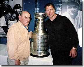 Baseball legend Yogi Berra poses with Scott Stevens and the Stanley Cup.