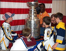 Children gather around the Stanley Cup