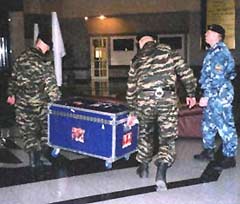 Russian security escorts Lord Stanley upon its arrival at the airport.