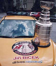 The Stanley Cup sits on the hood of Bicek's Mazda 6.