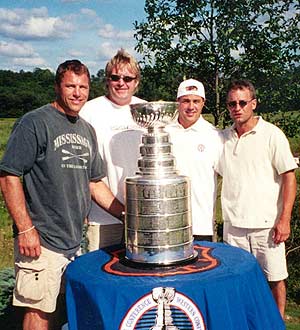 Scott Stevens and his brother Geoff, a Devils' scout (second from left), pose with friends at the home of Scott's parents before heading off to the cottage.