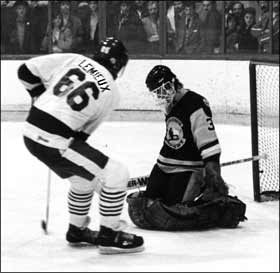 Patrick Roy stops Mario Lemieux during a Quebec Major Junior Hockey League game.