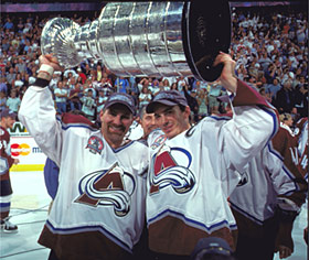 Joe Sakic and Raymond Bourque raise the Stanley Cup in triumph following their win in 2001.