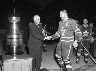 NHL President Clarence Campbell congratulates Maple Leaf captain George Armstrong at the conclusion of Game 7 of the 1964 Stanley Cup Final at Maple Leaf Gardens.