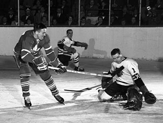 Frank Mahovlich in action here against Glenn Hall and the Chicago Black Hawks made his debut with the Toronto Maple Leafs in 1956-57.