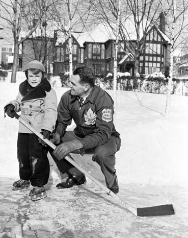 Syl Apps and his son Syl Apps Jr. in the backyard rink.