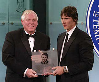 Dan Brooks, son of the late Herb Brooks accpets his fathers honoured members plaque from Hockey Hall of Fame Chairman and CEO, Bill Hay after being inducted posthumously into the Hockey Hall of Fame in 2006.