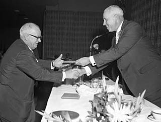 Clarence Campbell presents Jack Adams with his Honoured Members plaque after being inducted in 1959.