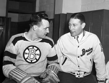Boston Bruins head coach Dit Clapper talks to one of his players.