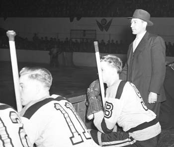 Dit Clapper behind the Boston Bruins bench.