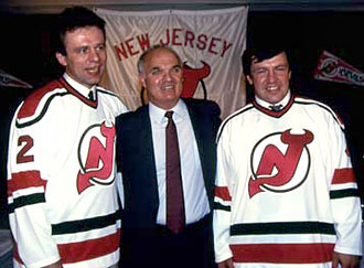 Lou Lamoriello along with newest members of the New Jersey Devils Viacheslav Festisov and Sergei Starikov