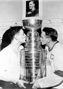 Captain Sid Abel and goaltender Terry Sawchuk celebrate their Stanley Cup championship.
